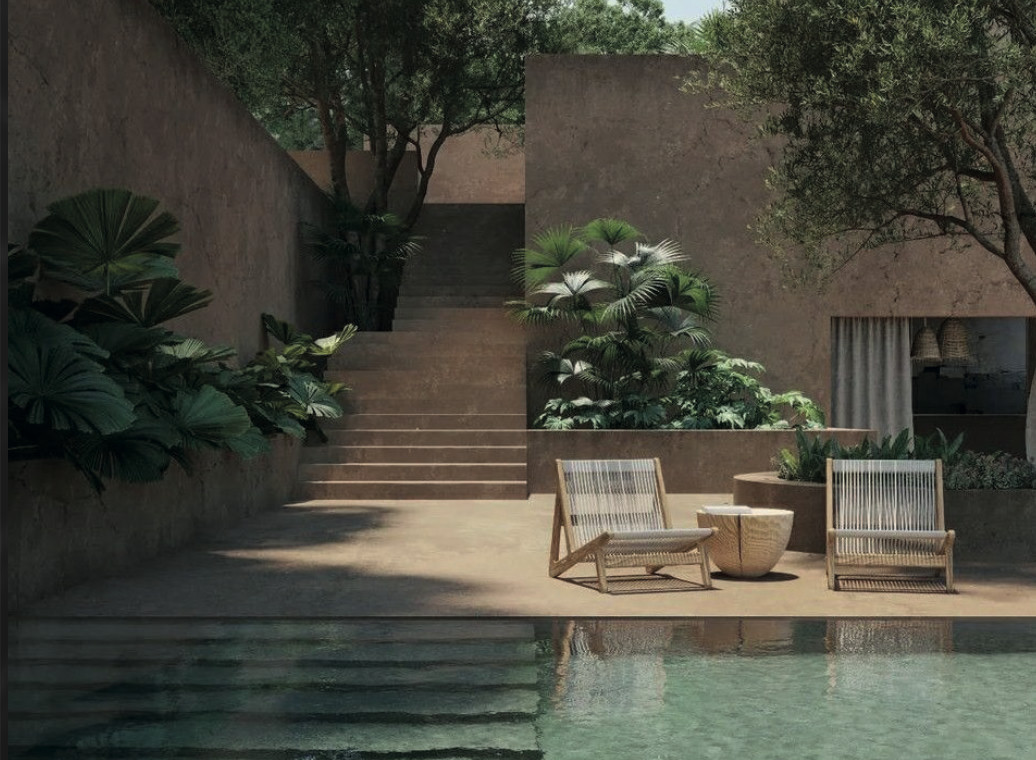 Terrasse en pierre avec piscine et végétation luxuriante d'une propriété de caractère